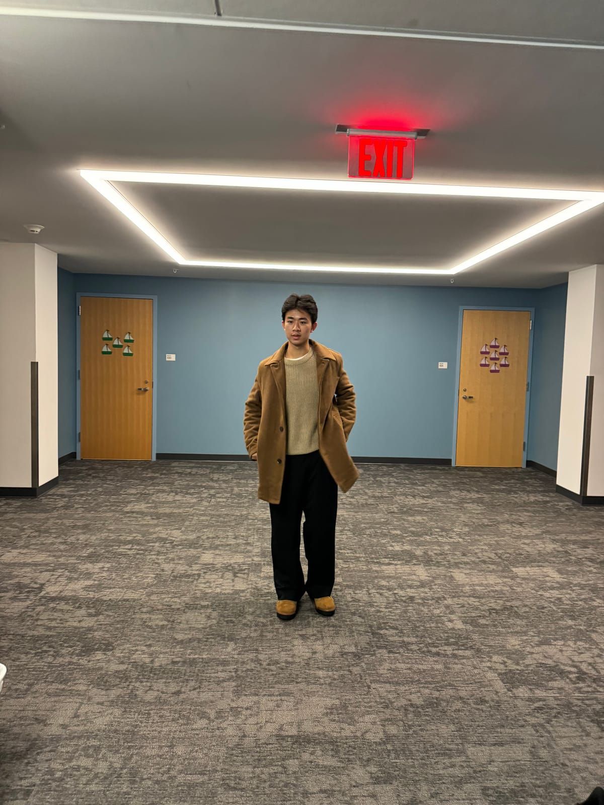 Joshua in a camel overcoat
