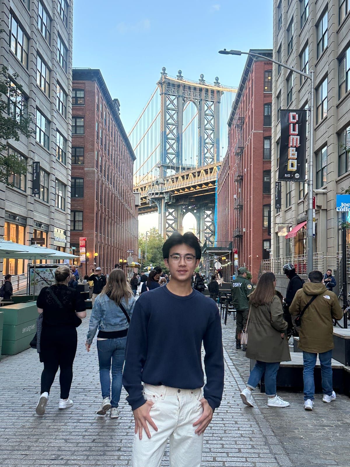 Joshua in DUMBO, Brooklyn, with the Manhattan Bridge behind