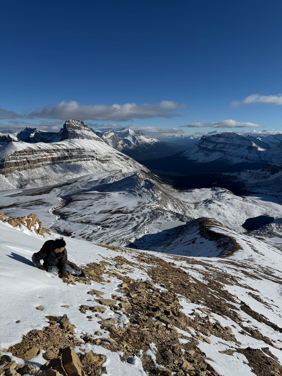 Joshua scrambling up a snowy summit ridge